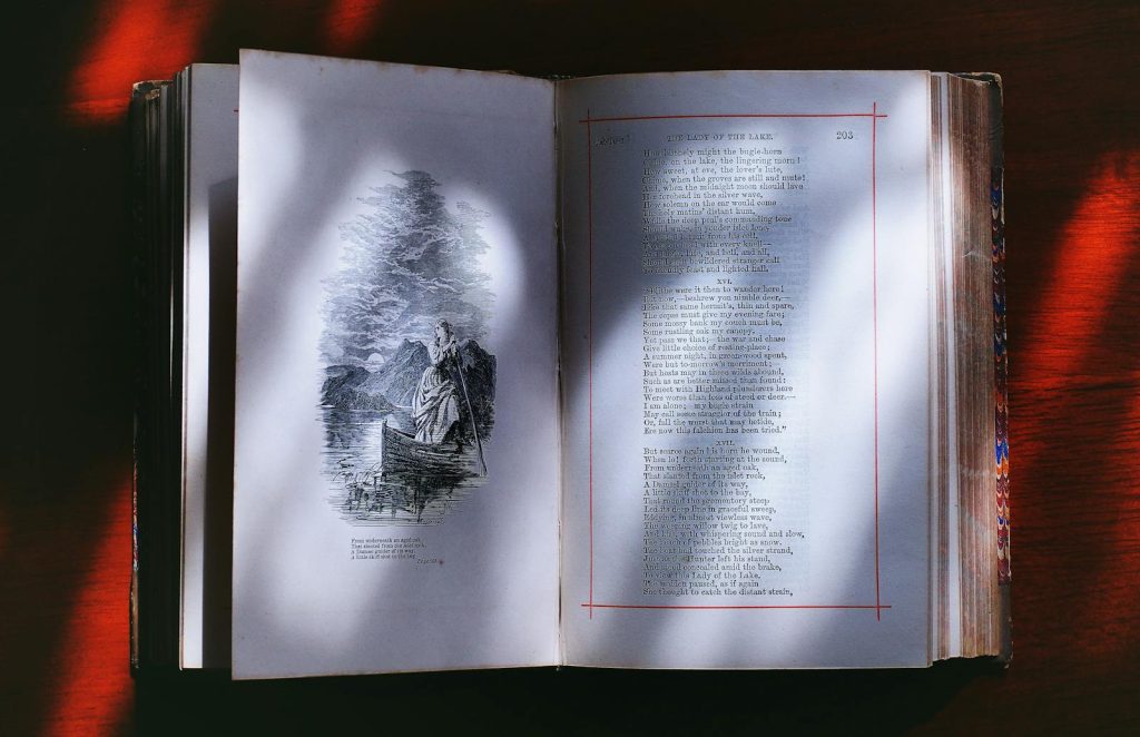 An open vintage book displaying illustrated poetry pages, creating an artistic literary ambiance.